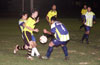 Joe Fromm of Race Lane(yellow) inbetween two Tuxpan defenders