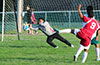 John Cabrera of FC Tuxpan about to save the shot taken by David Rodriguez of Tortorella Pools(#9)
