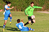 Jose Almansa of Hampton FC jumping over the slide tackle of Cristian Munoz of Tortorella Pools