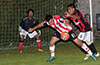 Bateman Painting forward, Jonathan Lizano, guarding the ball in front of the Sag Harbor goal