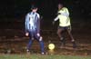 Mario Robles of Tuxpan(left) holding off Richard Scott of Rottweilers(right)