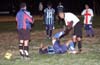 An injuried Tuxpan player being helped out by Carlos Torres of Bateman