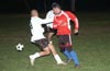 Julian Munoz(#8) and Christian Montes(rear) of Bateman holding Luis Vas of Tortorella from the ball