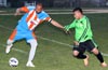Cesar Galeas of The Hideaway(left) trying to get the shot off before it can be blocked by a Hampton FC defender