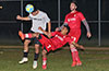 Maicol Parra of East Hampton heading the ball as Jeremias Simon of Sag Harbor trying to do a bicycle kick