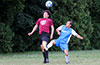 Mark Bako of East Hampton heading the ball in front of Cristian Munoz of Tortorella Pools