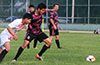 Donald Martinez of FC Tuxpan(center) holding off a FC Palora player